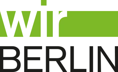 Logo mit grünem „wir“ und schwarzem „BERLIN“ darunter